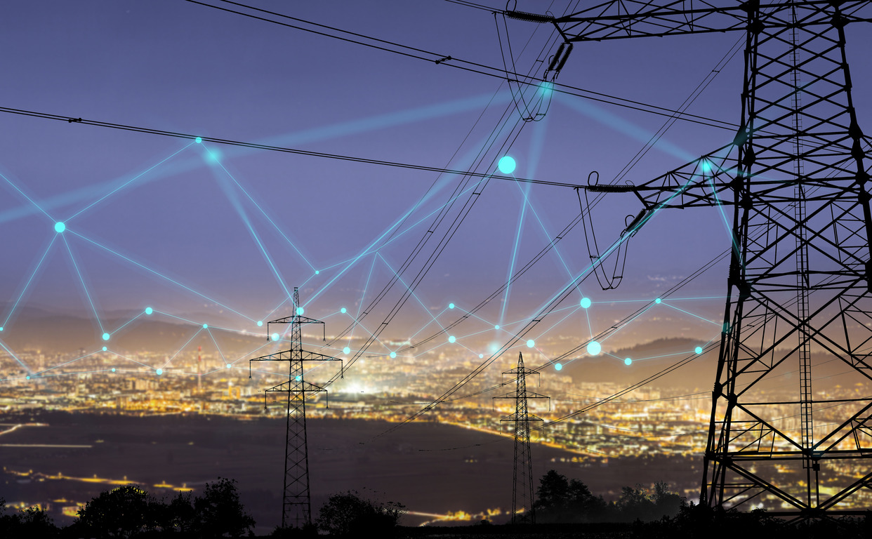 High power electricity poles in urban area connected to smart grid. Energy supply, distribution of energy, transmitting energy, energy transmission, high voltage supply concept photo.